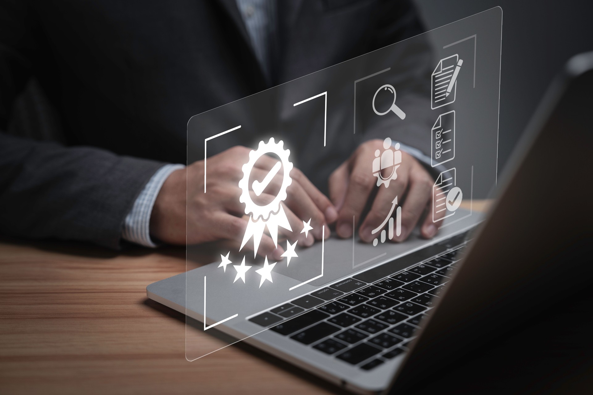 Businessman using laptop computer with quality assurance and document icon for ISO or International Standard Organisation which related quality control and continuous improvement concept.