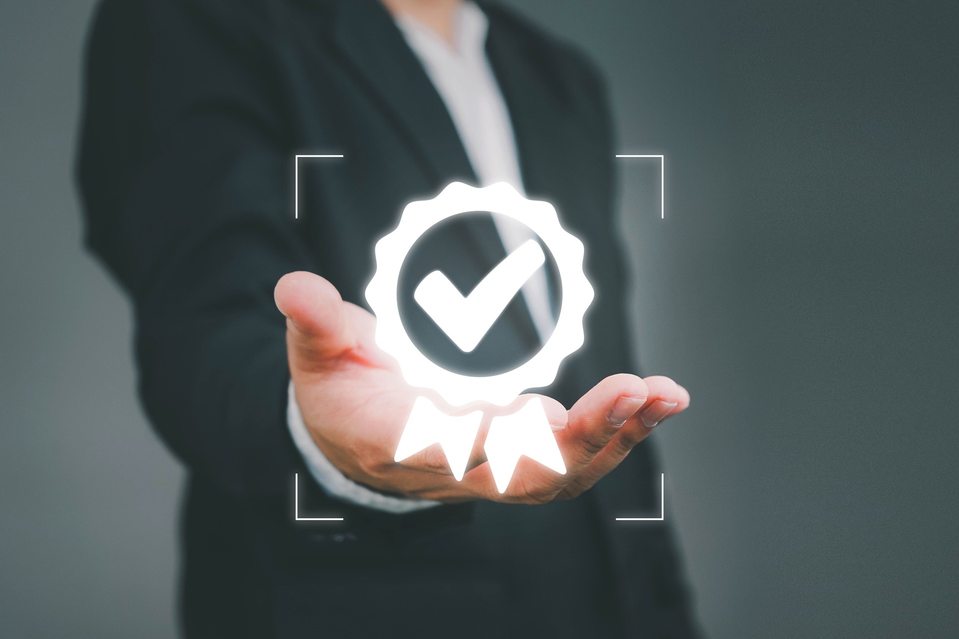 Hand shows the sign of the top service Quality assurance, ISO certification and standardization concept, Standard quality control certification assurance guarantee, Concept. Guarantee, Standards