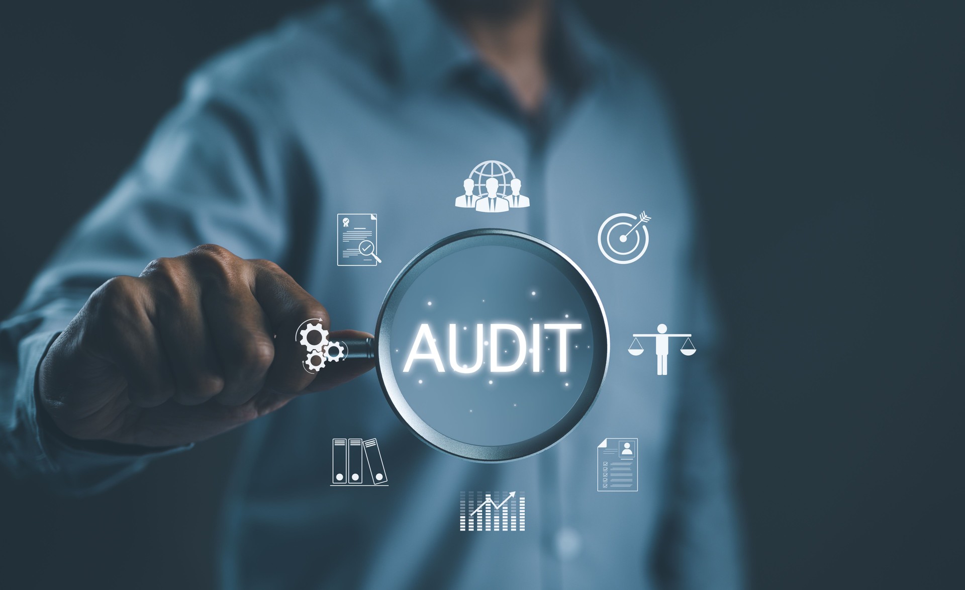 Audit business concept. Businessman holding magnifying glass with word "AUDIT" and business icons. Check to examine accounting and finance of business, Evaluation financial, standard certification,